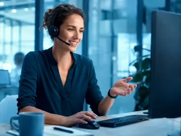 A specialist wearing a headset at a contact-centre workstation